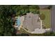 Aerial view showcasing the home's layout, private pool, spa, and lush surroundings within property lines at 3560 Greenside Ct, Dacula, GA 30019