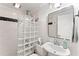 This bathroom features a glass block shower with classic black and white tile at 3560 Greenside Ct, Dacula, GA 30019