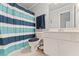 Cozy bathroom with a blue striped shower curtain, white vanity, and a toilet with a comfortable cushioned seat at 3560 Greenside Ct, Dacula, GA 30019