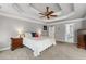 Main bedroom suite featuring a tray ceiling, neutral color palette, and an en-suite bathroom for added convenience at 3560 Greenside Ct, Dacula, GA 30019
