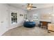 Bedroom with cozy beanbag, ceiling fan, large windows, and a desk, perfect for relaxing or studying at 3560 Greenside Ct, Dacula, GA 30019