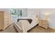Comfortable bedroom with white comforter, bedside table, and lots of natural light through a window at 3560 Greenside Ct, Dacula, GA 30019