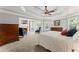 Spacious main bedroom with a fireplace, sitting area, and large windows, offering a cozy and inviting atmosphere at 3560 Greenside Ct, Dacula, GA 30019