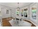 Sunlit dining room with views of the covered porch, complemented by a modern chandelier and white wood accents at 3560 Greenside Ct, Dacula, GA 30019