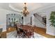 Elegant dining room with hardwood floors, classic chandelier, and open concept living at 3560 Greenside Ct, Dacula, GA 30019