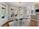 Light-filled dining room connects to the porch with a view of the stone fireplace and living space at 3560 Greenside Ct, Dacula, GA 30019