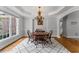 Elegant dining room with hardwood floors, classic chandelier, and large bay windows at 3560 Greenside Ct, Dacula, GA 30019