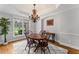 Elegant dining room with hardwood floors, classic chandelier, and beautiful natural light at 3560 Greenside Ct, Dacula, GA 30019