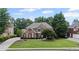 Beautiful brick home features a manicured lawn and mature trees, enhancing its curb appeal at 3560 Greenside Ct, Dacula, GA 30019
