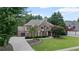 Charming brick home with a well-manicured lawn and a long driveway leading to the garage at 3560 Greenside Ct, Dacula, GA 30019