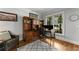 A cozy home office with hardwood floors, large built-in bookcase, and natural light at 3560 Greenside Ct, Dacula, GA 30019