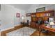 A cozy home office with hardwood floors and a large built-in bookcase, perfect for remote work at 3560 Greenside Ct, Dacula, GA 30019