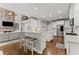 Modern kitchen with marble countertops, stainless steel appliances, and hardwood floors throughout at 3560 Greenside Ct, Dacula, GA 30019