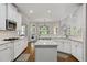 Open kitchen with marble countertops, white cabinets and modern stainless steel appliances at 3560 Greenside Ct, Dacula, GA 30019