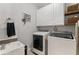Well-appointed laundry room featuring modern washer and dryer, ample cabinet space, and a convenient sink at 3560 Greenside Ct, Dacula, GA 30019