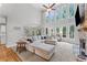Bright living room with a high ceiling, fireplace, and large windows providing plenty of natural light at 3560 Greenside Ct, Dacula, GA 30019