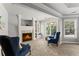 Living room featuring a fireplace, built-in shelving, and comfortable seating, creating an ideal spot for relaxation at 3560 Greenside Ct, Dacula, GA 30019