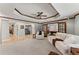 A basement living room with a coffered ceiling and an archway leading to another room at 3560 Greenside Ct, Dacula, GA 30019