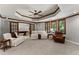 Basement living room with a coffered ceiling, large windows, and plush seating at 3560 Greenside Ct, Dacula, GA 30019