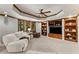 Basement living room featuring a coffered ceiling, built-ins, and large windows at 3560 Greenside Ct, Dacula, GA 30019