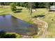 Aerial view of the golf course bordering the property, complete with a pond at 55 Forest Rd, Stockbridge, GA 30281