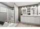 Bathroom with double sinks, cabinets, and shower with glass door at 55 Forest Rd, Stockbridge, GA 30281