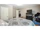 Bedroom with a large bed, door to another room, and dresser with TV at 55 Forest Rd, Stockbridge, GA 30281
