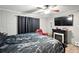 Bedroom with an electric fireplace, ceiling fan and mounted TV at 55 Forest Rd, Stockbridge, GA 30281