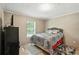 Cozy bedroom with a window, ceiling fan, and natural light at 55 Forest Rd, Stockbridge, GA 30281