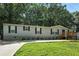Charming single-story home with a well-manicured lawn and inviting entryway at 55 Forest Rd, Stockbridge, GA 30281