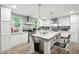Bright kitchen featuring white cabinets, stainless steel appliances, and large center island at 55 Forest Rd, Stockbridge, GA 30281