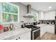 Modern kitchen with stainless steel range hood, appliances and ample counter space at 55 Forest Rd, Stockbridge, GA 30281