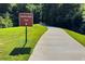 Paved Reeves Creek Trail winds through a lush green landscape, inviting leisurely walks and outdoor activities at 55 Forest Rd, Stockbridge, GA 30281