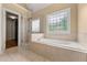 Bright bathroom features a tiled garden tub and large glass shower at 917 Saints Ct, Marietta, GA 30068