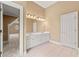 Bathroom vanity with double sinks, ample lighting, and access to another room at 917 Saints Ct, Marietta, GA 30068
