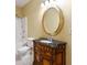 Charming bathroom with vintage vanity, oval mirror, and shower/tub combo at 917 Saints Ct, Marietta, GA 30068