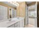 Bathroom featuring a double vanity, white cabinets, and a well-lit mirror at 917 Saints Ct, Marietta, GA 30068