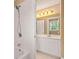 Bright bathroom with a tiled shower, tub, and single vanity with modern fixtures at 917 Saints Ct, Marietta, GA 30068