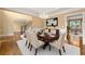 Formal dining room with hardwood floors, chandelier, and wainscoting adjacent to staircase at 917 Saints Ct, Marietta, GA 30068