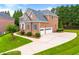 A well-maintained home with a spacious driveway leading to a two-car garage and lush green lawn at 917 Saints Ct, Marietta, GA 30068