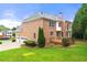 Brick home with manicured lawn, a back deck and attached garage at 917 Saints Ct, Marietta, GA 30068