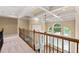 Upper hallway with iron banister overlooking the living room with coffered ceilings at 917 Saints Ct, Marietta, GA 30068