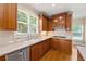 This kitchen boasts beautiful wood cabinetry, stainless steel appliances, and a sunny window at 917 Saints Ct, Marietta, GA 30068
