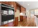 Modern kitchen features stainless steel appliances, custom cabinetry, and hardwood flooring at 917 Saints Ct, Marietta, GA 30068