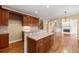 Open concept kitchen with wood floors, island and view into living room with fireplace at 917 Saints Ct, Marietta, GA 30068