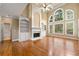 Bright living room with built-in bookcases, fireplace, hardwood floors and large windows at 917 Saints Ct, Marietta, GA 30068