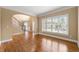 Bright living room featuring hardwood floors, neutral paint, staircase, and large windows at 917 Saints Ct, Marietta, GA 30068