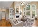 Spacious living room with built-in bookcases, fireplace, ceiling fan, and abundant natural light at 917 Saints Ct, Marietta, GA 30068