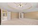 Spacious primary bedroom with a tray ceiling and ensuite bathroom access at 917 Saints Ct, Marietta, GA 30068