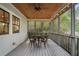Relaxing screened-in porch with wood ceiling, ceiling fan, string lights, and painted wood flooring at 1066 High Point Dr, Atlanta, GA 30306